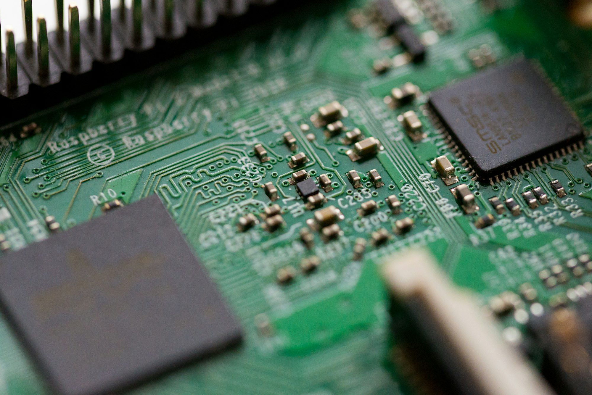 Close-up of a green circuit board with microchips