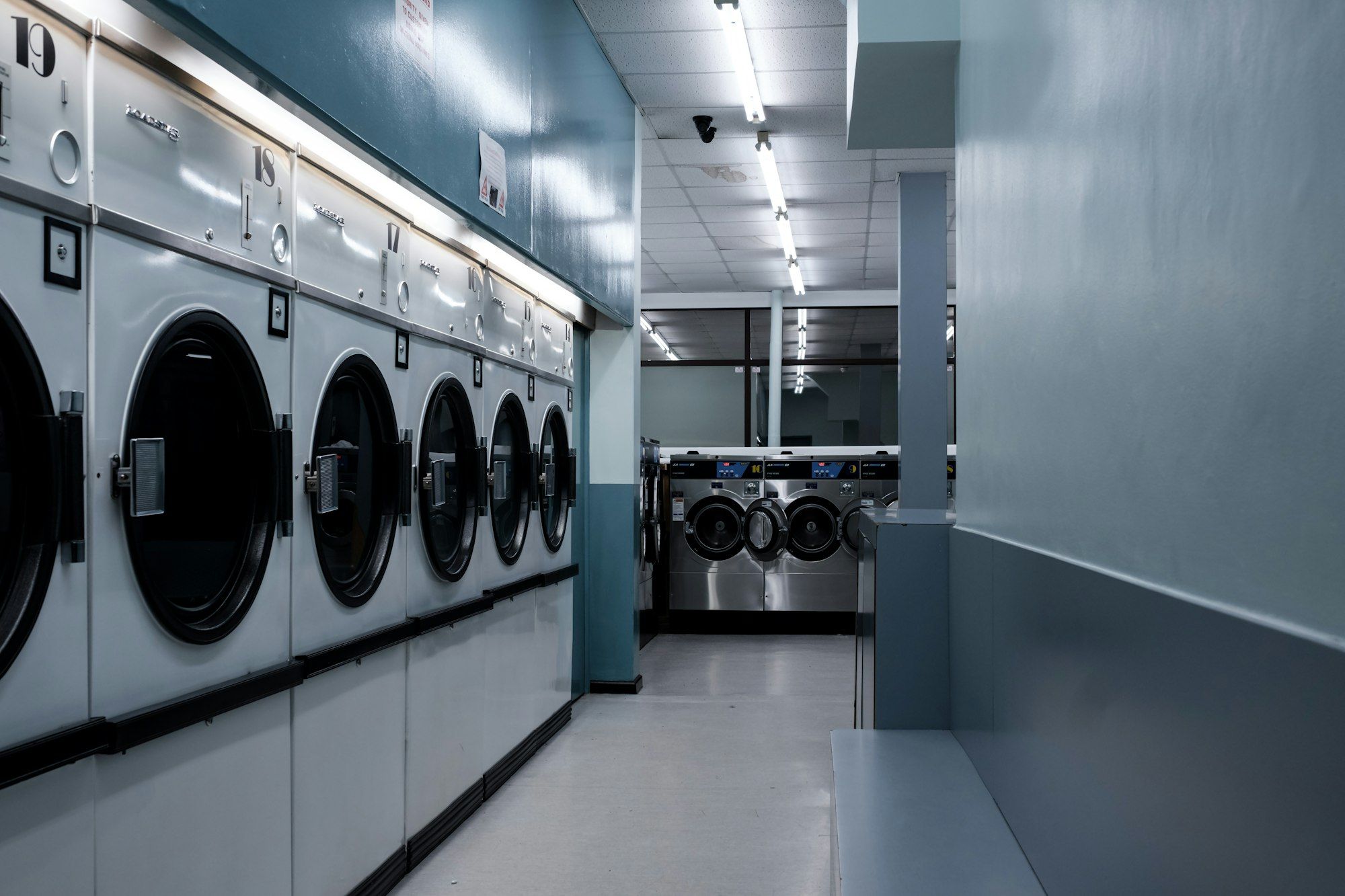 A row of front-loading washing machines